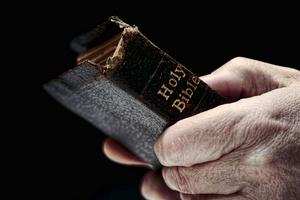 Old Bible, aged hands. Dreamstime/TCA