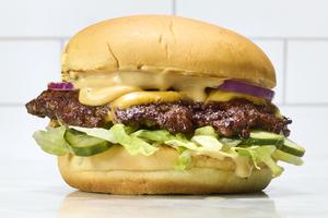 Learn how to cook thin, crispy smash burgers on the stovetop with gooey American cheese and buttery toasted buns. (Alex Lepe/TCA)