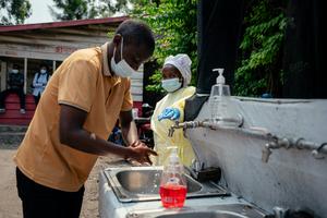 A man washes his hands before being screened to enter Kyeshero Hospital in Goma, Congo, on May 18, 2026.  Jospin Mwisha/AFP via Getty Images