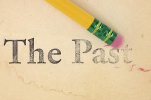 Erasing The Past. Close up of a yellow pencil erasing the words, 'The Past' from old, yellowed paper. Dreamstime/TCA