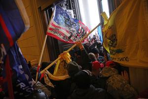 WASHINGTON, DC - JANUARY 06: Protesters supporting U.S. President Donald Trump break into the U.S. Capitol on January 6, 2021 in Washington, DC. Congress held a joint session today to ratify President-elect Joe Biden's 306-232 Electoral College win over President Donald Trump.  Pro-Trump protesters entered the U.S. Capitol building during demonstrations in the nation's capital.  (Photo by Win McNamee/Getty Images)