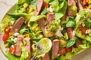 This flavorful salad with seared strip steak and fresh veggies is ready in 30 minutes. (Alex Lepe/TCA)