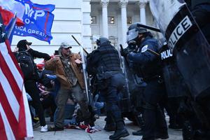Trump supporters clash with police and security forces, as they storm the U.S. Capitol in Washington, D.C., on Jan. 6, 2021. (Brendan Smialowski/AFP/Getty Images/TNS)