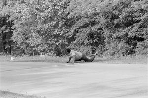 James Meredith looks at Aubrey Norvell, partially hidden behind foliage, after Norvell shot him in Hernando, Miss., on June 6, 1966. AP Photo/Jack Thornell
