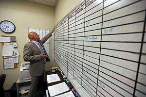 A court interpreter checks the day's schedule of assignments. AP Photo/Brennan Linsley