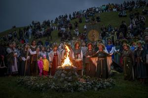 People wear traditional clothes as they celebrate St. John's Day and the summer solstice in Kernave, Lithuania, on June 23, 2024.  AP Photo/Mindaugas Kulbis