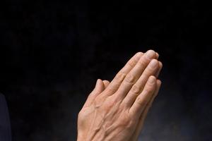 Praying man. Dreamstime/TCA