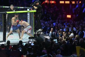U.S. President Donald Trump, right, watches the lightweight title bout between Georgia's Ilia Topuria and America's Justin Gaethje during the 