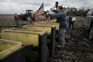 Alan Montag, a third-generation Iowa farmer, and his son Aden load soybean seed into a planter on May 6, 2026. Scott Olson/Getty Images