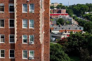 Air conditioner units sit in windows of an apartment building on July 20, 2022, in Washington, DC. (Anna Moneymaker/Getty Images/TNS)