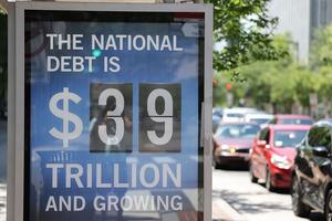 WASHINGTON, DC - JUNE 12:  A Peterson Foundation bus stop sign displays the national debt on June 12, 2026 in Washington, DC. (Photo by Tasos Katopodis/Getty Images for the Peter G. Peterson Foundation)