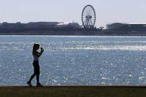 A person walks the trail along Lake Michigan at Chicago's North Avenue Beach. AP Photo/Charles Rex Arbogast