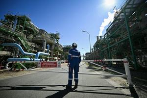 A worker stands at a TotalEnergies refinery in northwestern France. Lou Benoist/AFP via Getty Images