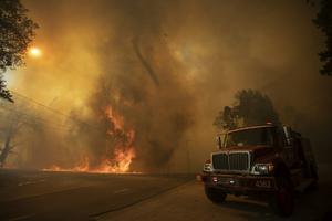 A fire whirl, or fire tornado, rises from flames near Wofford Heights, Calif., in August 2021. David McNew/Getty Images