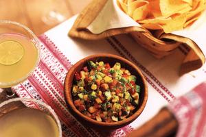 Carrots, sweet bell peppers, raw corn and diced avocado are added to the simple tomato salsa. (Maura McEvoy/TCA)