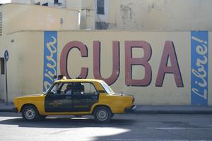Cuba Sign. Cuba libre sign on wall with taxi, Havana, Cuba. Dreamstime/TCA