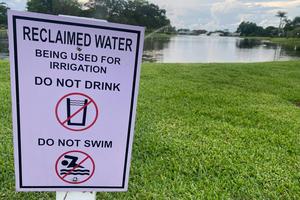 A sign warns passers-by that irrigation in the area uses treated sewage wastewater. Lindsey Nicholson/UCG/Universal Images Group via Getty Images