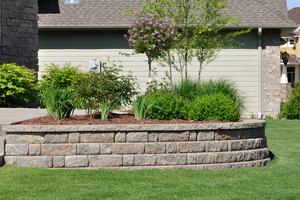 For a basic retaining wall to contain a flower or vegetable bed, concrete blocks are a popular choice. (Dreamstime/TCA)