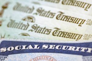 In this photo illustration, a Social Security card sits alongside checks from the U.S. Treasury on Oct. 14, 2021, in Washington, D.C. (Kevin Dietsch/Getty Images/TNS)