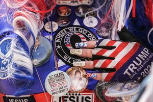 A woman touches a QAnon patch on her outfit during a Christian prayer gathering in Washington on May 17, 2026. AP Photo/Julia Demaree Nikhinson