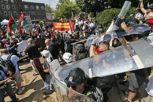 White nationalist demonstrators clash with counterdemonstrators at the entrance to Lee Park in Charlottesville, Va., on Aug. 12, 2017.  AP Photo/Steve Helber
