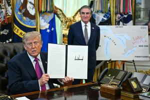 TOPSHOT - US President Donald Trump, alongside Secretary of the Interior Doug Burgum, displays an executive order he signed that aims to rename Lake Ontario to Lake America in the Oval Office of the White House in Washington, DC, on August 27, 2026. President Donald Trump announced Thursday that he is renaming Lake Ontario -- a large body of water shared by the United States and Canada -- 