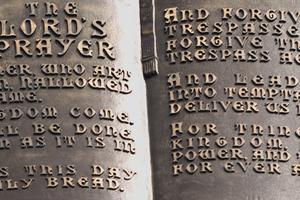 Close-up of the lord's prayer on a statue. Dreamstime/TCA