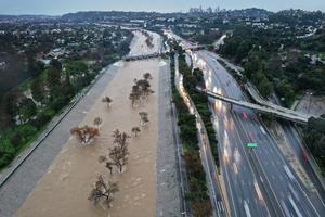 Heavy rain from an atmospheric river sent the Los Angeles River, normally mostly empty, spilling over its sides in February 2024. Mario Tama/Getty Images