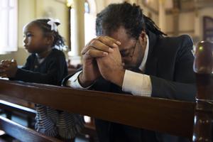 Christians praying. Dreamstime/TCA