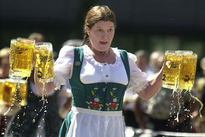 CINCINNATI - SEPTEMBER 17:  Annamarie Harten competes in a beer stein race as part of the Gemuetlichkeit Games held as a promotion for Oktoberfest Zinzinnati September 17, 2003 in Cincinnati. Competitors carry 6 beer 1-liter beer steins, which weigh about 30 pounds, a short distance and are penalized for spilled beer. Oktoberfest Zinzinnati is the nation's largest and most authentic Oktoberfest, and will take place September 20 and 21.  (Photo by Mike Simons/Getty Images)