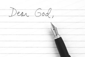 Dear God. Writing a letter to God for guidance and prayer. Dreamstime/TCA