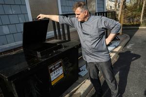 A restaurant owner looks at a tank for collecting used cooking oil. Steve Pfost/Newsday RM via Getty Images