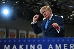 US President Donald Trump dances as he departs after delivering remarks at the Nassau County Police Academy Center for Training and Intelligence in Garden City, New York, on August 14, 2026. (Photo by Kent NISHIMURA / AFP via Getty Images)