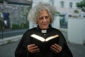 Clergy reading Bible. Dreamstime/TCA