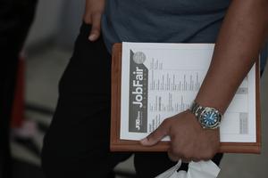 A job seeker holds paperwork during the Mega JobNewsUSA South Florida Job Fair held in the Amerant Bank Arena on Sept. 25, 2026, in Sunrise, Fla. Hiring managers and recruiters from more than 50 companies attended the job fair to recruit workers for opportunities across a range of companies. (Joe Raedle/Getty Images/Tribune Content Agency)