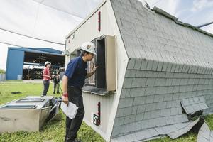 Hurricane-force winds from the Wall of Wind test facility rolled mobile homes, showing where their anchoring systems fail. Margi Rentis/Florida International University