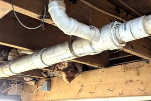 This PVC tee fitting connects a toilet to the main drain line. There are two serious code violations here. This is why you need to have a knowledgeable inspector look at all mechanical systems in any house you intend to purchase. (Tim Carter/Tribune Content Agency). TNS