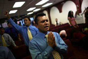 People pray during a service in a storefront church in the Little Havana neighborhood of Miami, Fla. Joe Raedle/Getty Images