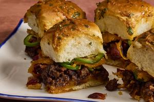 These cheesy barbecue sliders with ground beef and crispy bacon are a game-day favorite. (Erik Bernstein/TCA)