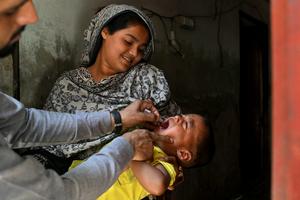 In Pakistan, where wild polio still has not been eliminated, health workers go door to door vaccinating young children. ARIF ALI/AFP via Getty Images