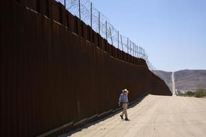 A volunteer walks along the U.S.-Mexico border near Jacumba Hot Springs, Calif., on June 5, 2025. AP Photo/Gregory Bull