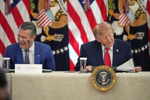 President Donald Trump speaks at a roundtable event at the White House on Oct. 21, 2026, as Defense Secretary Pete Hegseth laughs. AP Photo/Alex Brandon