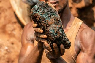 An artisanal miner holds a cobalt stone at a mine near Kolwezi, Congo, in 2022. About 20,000 people work there among toxic materials. Junior Kannah/AFP via Getty Images