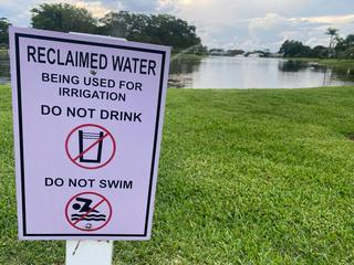 A sign warns passers-by that irrigation in the area uses treated sewage wastewater. Lindsey Nicholson/UCG/Universal Images Group via Getty Images